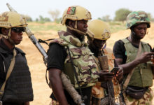 Nigerian army soldiers stand at a base