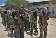 Al-Qaeda linked al-shabab recruits walk down a street on March 5, 2012 in the Deniile district of Somalian capital, Mogadishu
