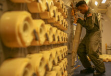 Naval Air crewman loads sonobuoys aboard a P-8A Poseidon aircraft. Photo: Lance Cpl. Joseph Atiyeh/USMC