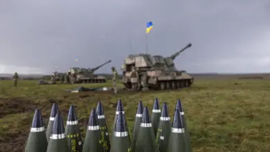 155mm artillery rounds stacked up behind the line of AS90s and their Ukrainian operators. Photographer: Corporal Rob Kane ©MoD Crown Copyright 2022