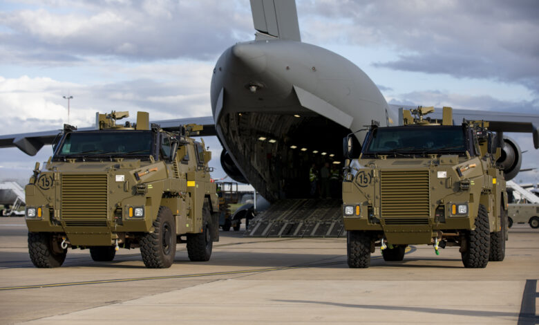 Two Bushmaster protected mobility vehicles bound for Ukraine wait to be loaded onto a C-17A Globemaster III aircraft at RAAF Base Amberley, Queensland. *** Local Caption *** The Australian Government has provided further support to the Government of Ukraine by gifting 20 Bushmaster Protected Mobility Vehicles, including two ambulance variants, to aid the Government of Ukraines response to Russias unrelenting and illegal aggression. Australias response follows a direct request from President Zelenskyy during his address to a joint sitting of the Parliament of Australia on 31 March 2022. The Bushmaster Protected Mobility Vehicle was built in Australia to provide protected mobility transport, safely moving soldiers to a battle area prior to dismounting for close combat. The Bushmaster Protected Mobility Vehicle is well suited to provide protection to the Ukrainian Armed Forces soldiers and Ukrainian civilians against mines and improvised explosive devices, shrapnel from artillery and small arms fire. The vehicles have been painted olive green to suit the operating environment. Additionally, a Ukrainian flag is painted on either side with the words United with Ukraine stencilled in English and Ukrainian to acknowledge our commitment and support to the Government and people of Ukraine. The ambulances will have the traditional red cross emblem. The Bushmaster Protected Mobility Vehicles will be fitted with radios, a global positioning system and additional bolt-on armour increasing their protection.