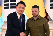 South Korean President Yoon Suk Yeol and his Ukrainian counterpart Volodymyr Zelensky shake hands following talks in Kyiv