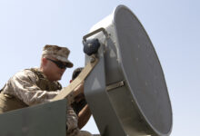 Gunnery Sgt. John Ciupak, an instructor for the VOCALIS training program, prepares a Long Range Acoustic Device at the Iraqi Ground Forces Command Headquarters in Baghdad, July 11, 2018. VOCALIS is an organization that works with the Combined Joint Task Force- Operation Inherent Resolve and tasked with building partnership capacity between the Coalition Forces and Iraqi government. The VOCALIS program is comprised of training packages taught by military and contractor activities, including a train the trainer program. (U.S. Army photo taken by Sgt. Dennis Glass)