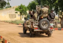 Nigerian Army soldiers are seen driving on a military vehicle in Ngamdu, Nigeria