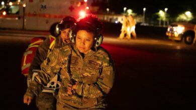 From right, U.S Air Force Maj. Ahryll Roberts, 374th Medical Group education and training flight commander, and U.S. Air Force Senior Airman Jasmin Garcia, 374th MDG medical technician, prepare to board a UH-1N Huey helicopter during a patient transport drill at Yokota Air Base, Japan, Dec. 18, 2023. Since 2019, the 459th Airlift Squadron and 374th MDG have successfully completed 14 medical transport missions, reducing patient travel time by over two hours for each leg of the journey.