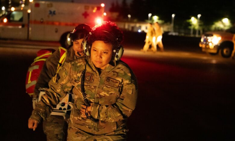 From right, U.S Air Force Maj. Ahryll Roberts, 374th Medical Group education and training flight commander, and U.S. Air Force Senior Airman Jasmin Garcia, 374th MDG medical technician, prepare to board a UH-1N Huey helicopter during a patient transport drill at Yokota Air Base, Japan, Dec. 18, 2023. Since 2019, the 459th Airlift Squadron and 374th MDG have successfully completed 14 medical transport missions, reducing patient travel time by over two hours for each leg of the journey.
