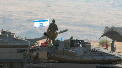 Israeli Merkava tanks are positioned in the north of Israel near the border with Lebanon.