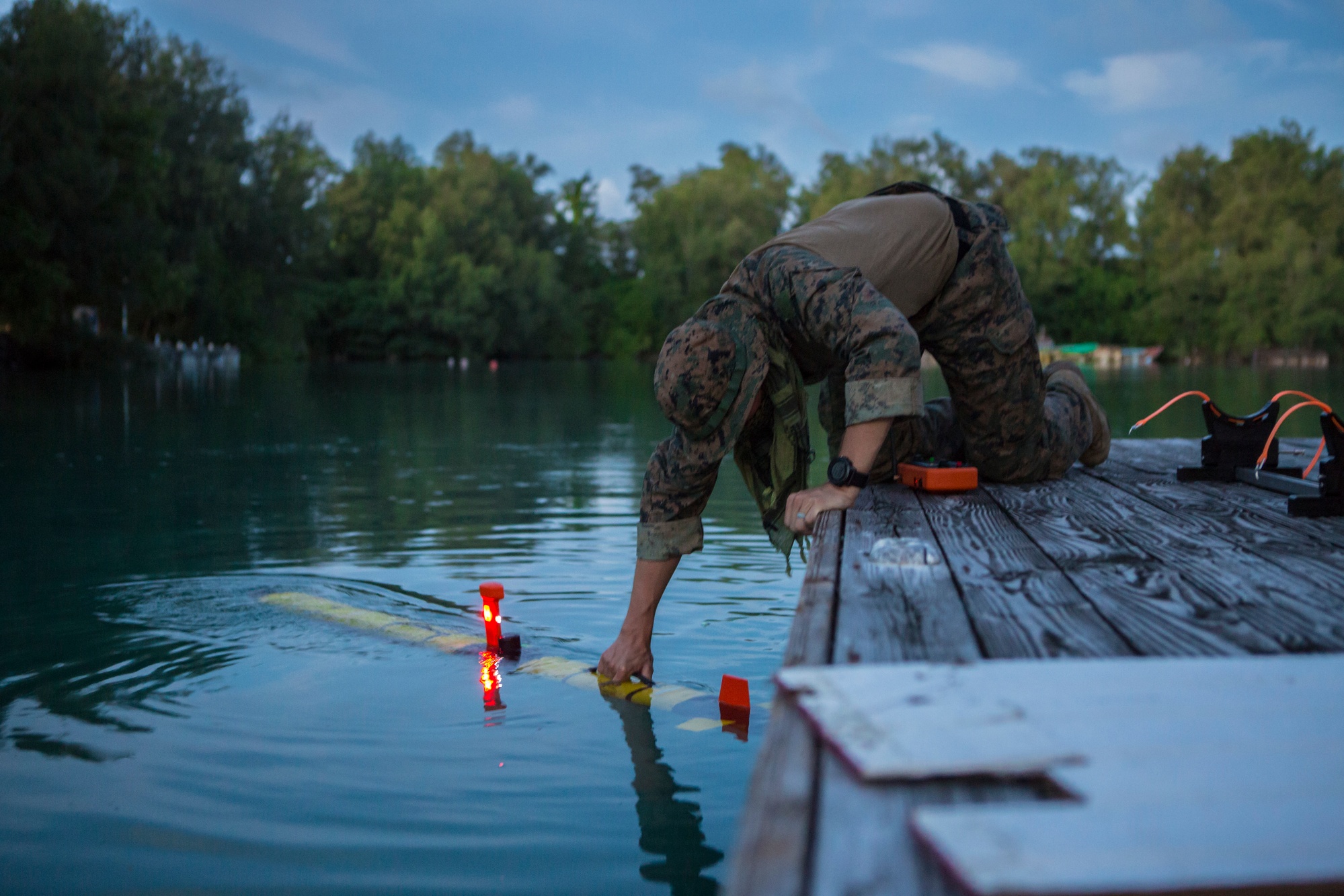 U.S. Marine Corps Staff Sgt. Paul Butcher, a Littoral Explosive Ordnance Neutralization (LEON) Marine, with Task Force Koa Moana (TF KM) 20, I Marine Expeditionary Force (MEF), prepares to conduct hydrographic surveys with the Iver 3 unmanned underwater vehicle in Peleliu, Republic of Palau, Aug. 2, 2020. Marines and Sailors with TF KM20, are conducting engagements in the Republic of Palau from July through September of 2020. Koa Moana, meaning “ocean warrior,” is designed to strengthen and enhance relationships between the U.S. and partner nations/states in the Indo-Pacific region, improve interoperability with local security establishments, and serve as a Humanitarian Assistance Survey Team afloat in support of U.S. Indo-Pacific Command’s strategic and operational objectives. TF KM20 provides a unique opportunity to enhance relationships in the Republic of Palau. The Koa Moana task force has taken extensive measures to mitigate the spread of COVID-19. The health and safety of U.S. service members and Palauan citizens participating in TF KM20 is an enduring priority. Prior to deploying, all exercise members participated in a three-week quarantine. After arriving in Palau, the Marines and Sailors remain quarantined for an additional 14 days. To date, all members deployed as part of TF KM20 tested negative for COVID-19. (U.S. Marine Corps photo by Cpl. Anabel Abreu Rodriguez)