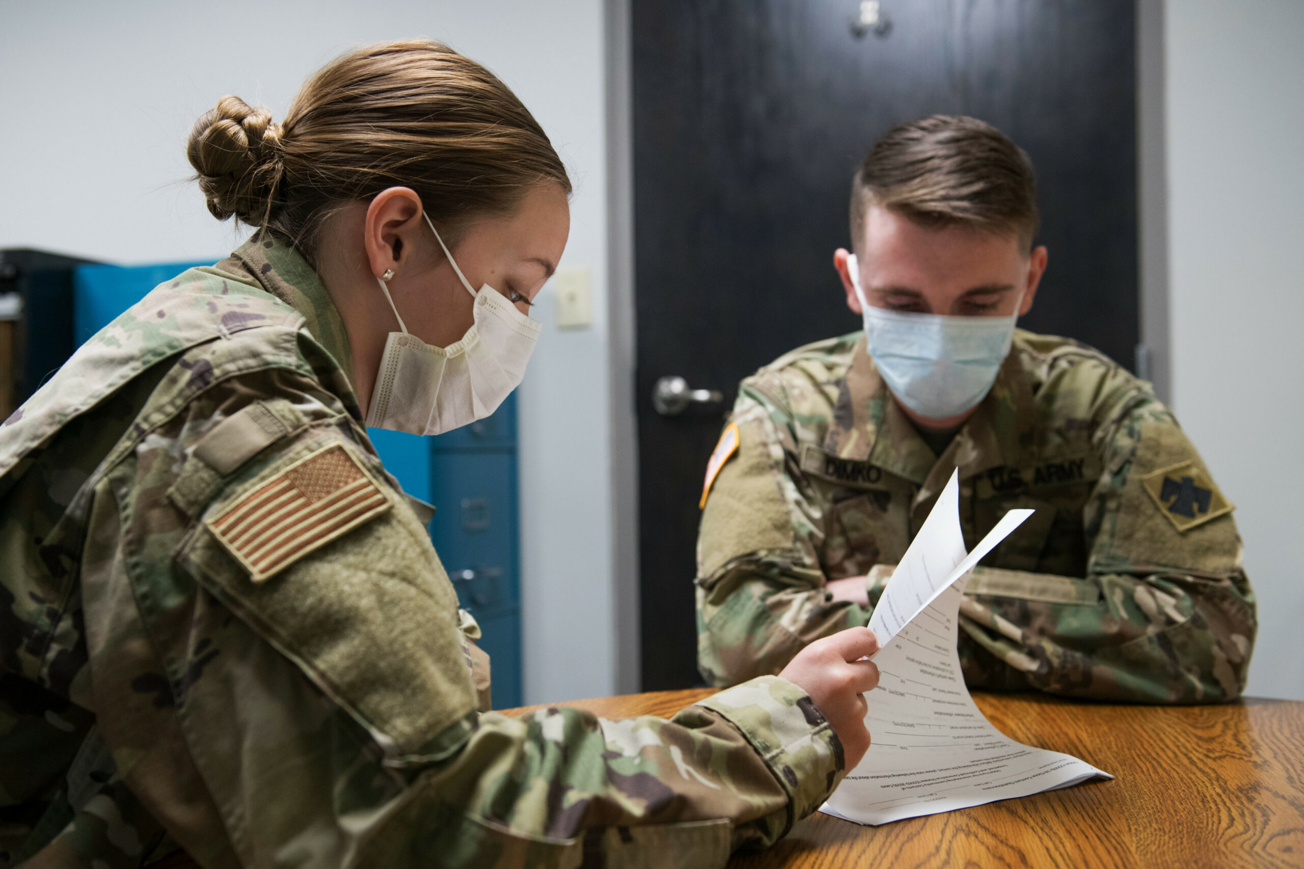 Airman Madison Hilton (left), a member of the Oklahoma Air National Guard's 138th Fighter Wing and Oklahoma Army National Guard Spc. Phillip Dimko (right), 120th Engineering Battalion, review documents for COVID-19 contact tracing on May 21, 2020 in Muskogee, Oklahoma. On May 21, there were eight members of the Oklahoma National Guard working contact tracing in Muskogee in order to advise individuals who may have been exposed to COVID-19 and provide them with necessary information on symptoms to look for, as well as testing sites if needed. (Oklahoma Air National Guard photo by Tech. Sgt. Rebecca Imwalle)