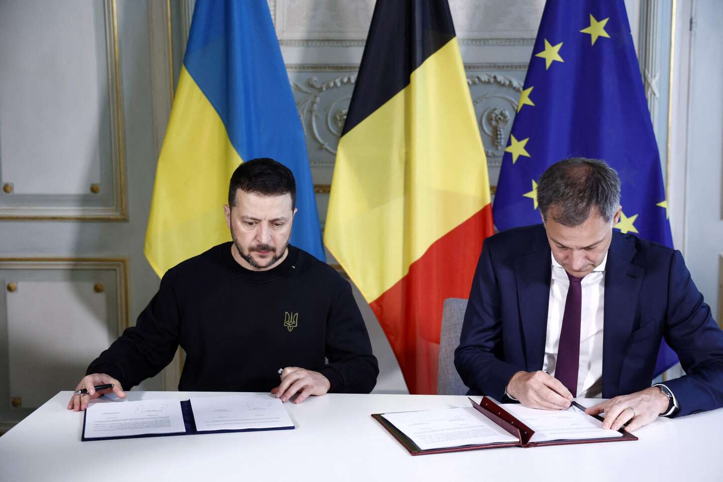 Ukraine's President Volodymyr Zelensky and Belgian Prime Minister Alexander De Croo sign a bilateral security accord in Brussels on May 28, 2024