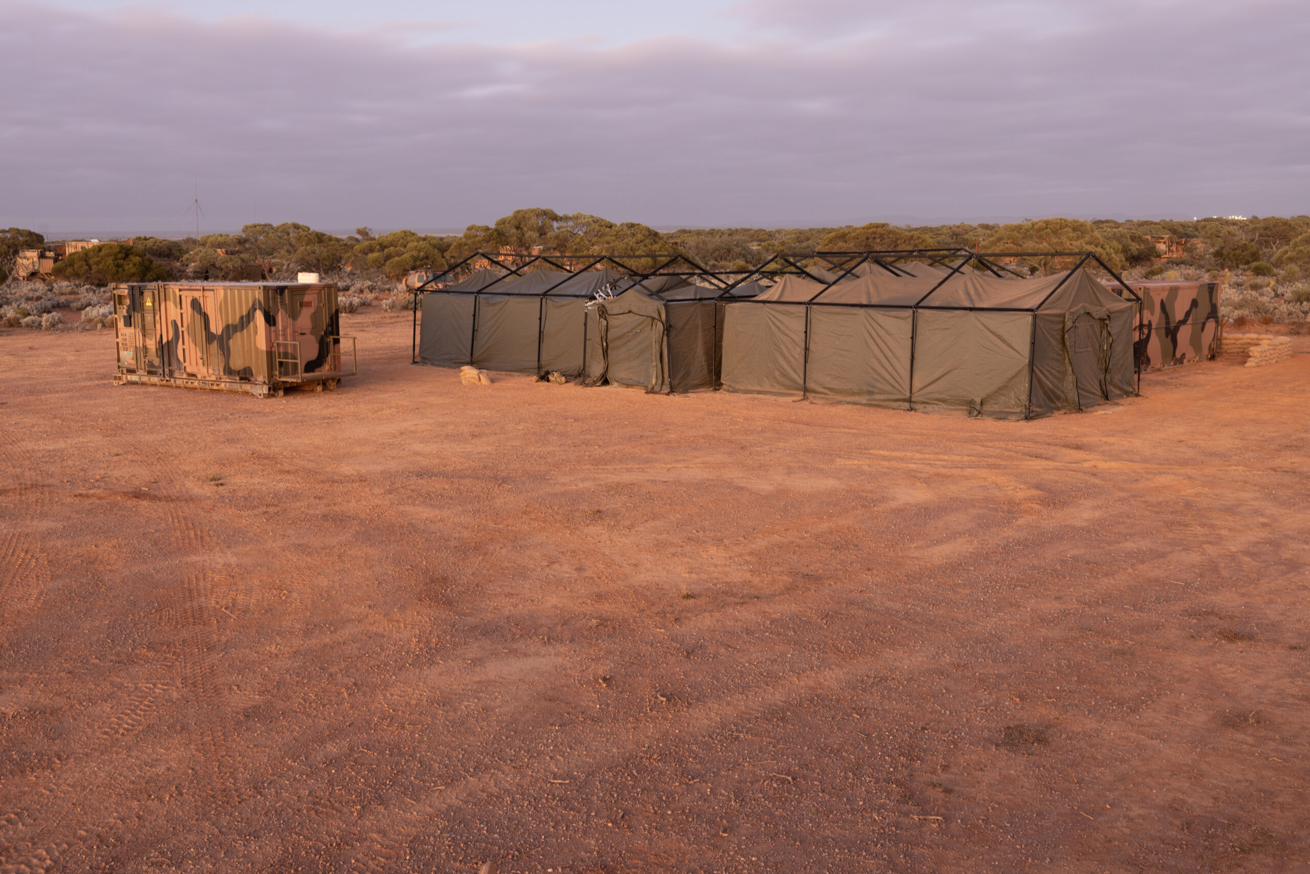 Australian Army Role 2 Basic field hospital set up by the 3rd Health Battalion during Exercise Rhino Run at Cultana Training Area. *** Local Caption *** The 3rd Health Battalion deployed their Role 2 Basic into the field environment on Exercise Rhino Run 2024. The Role 2 Basic is a manoeuvrable and deployable field hospital designed to offer urgent medical care, including resuscitation, surgery and critical care post-evacuation via medics in the field. The Role 2 Basic is suitable for all shape, deter and respond operations and is able to be deployed at short notice due to its ease of movement. Exercise Rhino Run 2024 is the culminating force generation event for the 9th Brigade in 2024 involving 1st Armoured Regiment, 7th Battalion, the Royal Australian Regiment, 10th/27th Battalion, Royal South Australia Regiment, 9th Combat Service Support Battalion, Headquarters 9th Brigade personnel, and equipment external supports from 3rd Health Battalion and United States Marine Corps. The activity includes a number of carefully synchronised unit live and dry fire activities in the Cultana Training Area (CUTA) with Direct Command Units working together to deliver individual and team training outcomes through supported and supporting arrangements.