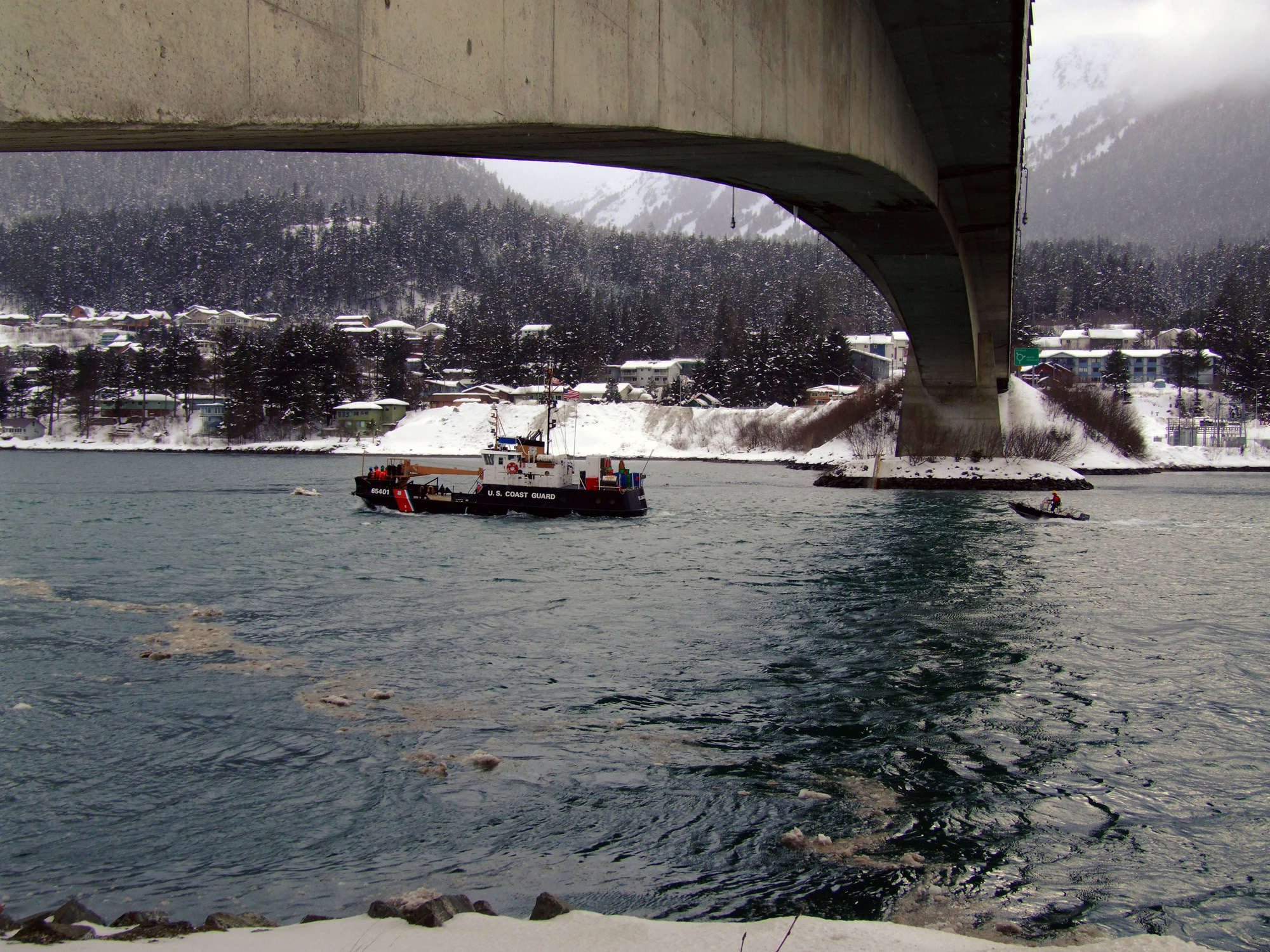 JUNEAU, Alaska (March 20, 2007)--The Coast Guard Cutter Elderberry transits the Gastineau Channel beneath the Juneau Douglas Island bridge after setting the seasonal bar buoys on March 20, 2007. The Elderberry is homeported in Petersburg, and will remove the buoys at the end of the recreational boating season. Official Coast Guard photo by Petty Officer Eric J. Chandler