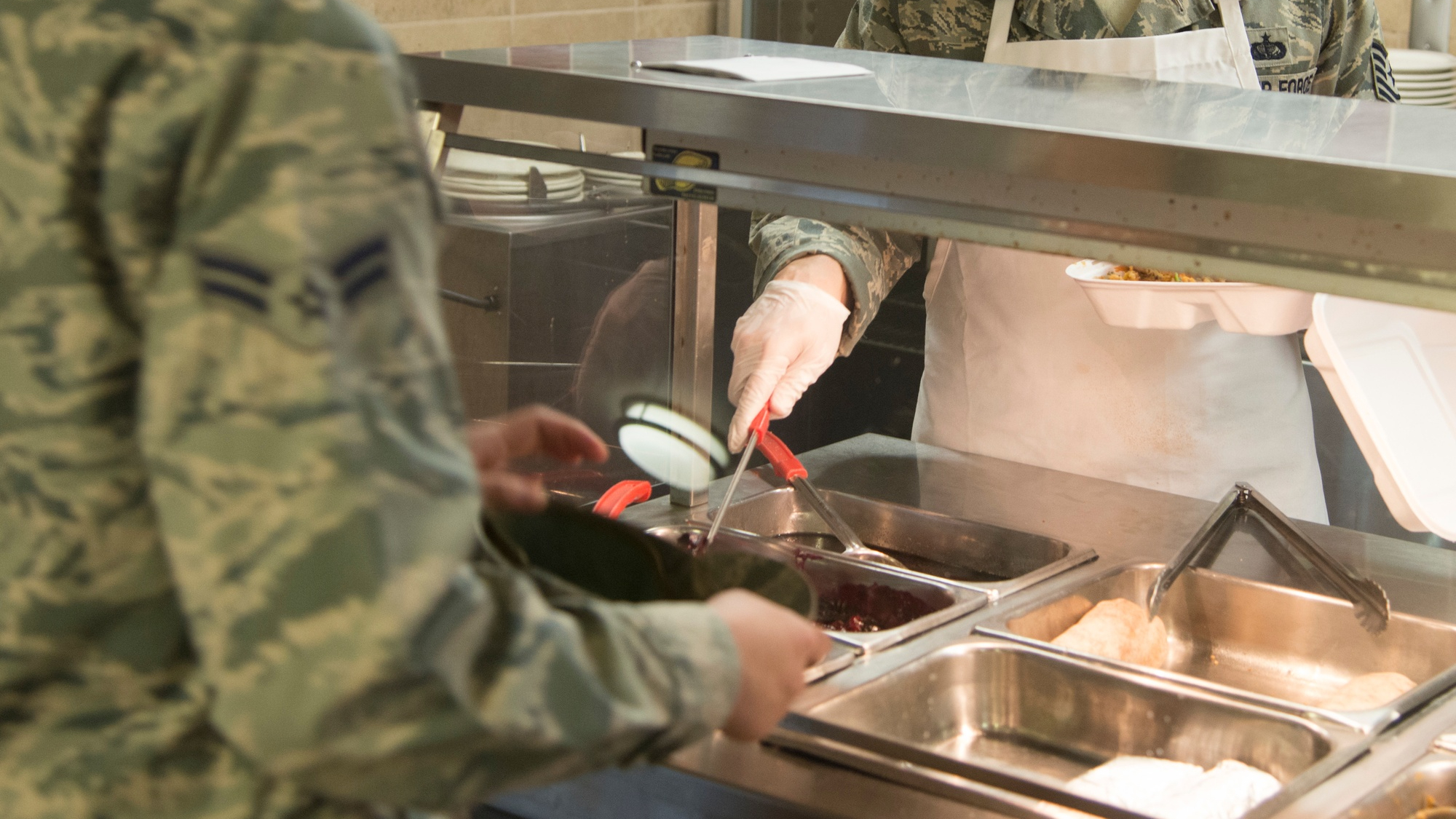 PETERSON AIR FORCE BASE, Colo. –Tech. Sgt. Oscar Santiago, 21st Force Support Squadron dining facility manager, serves a customer at the Aragon DFAC on Peterson Air Force Base, Colorado, Sept. 14, 2018. The food service specialists at the Aragon DFAC and surrounding bases underwent extensive culinary training Sept. 11-14, as part of the Department of Defense’s Go for Green initiative. (U.S. Air Force photo by Staff Sgt. Emily Kenney)