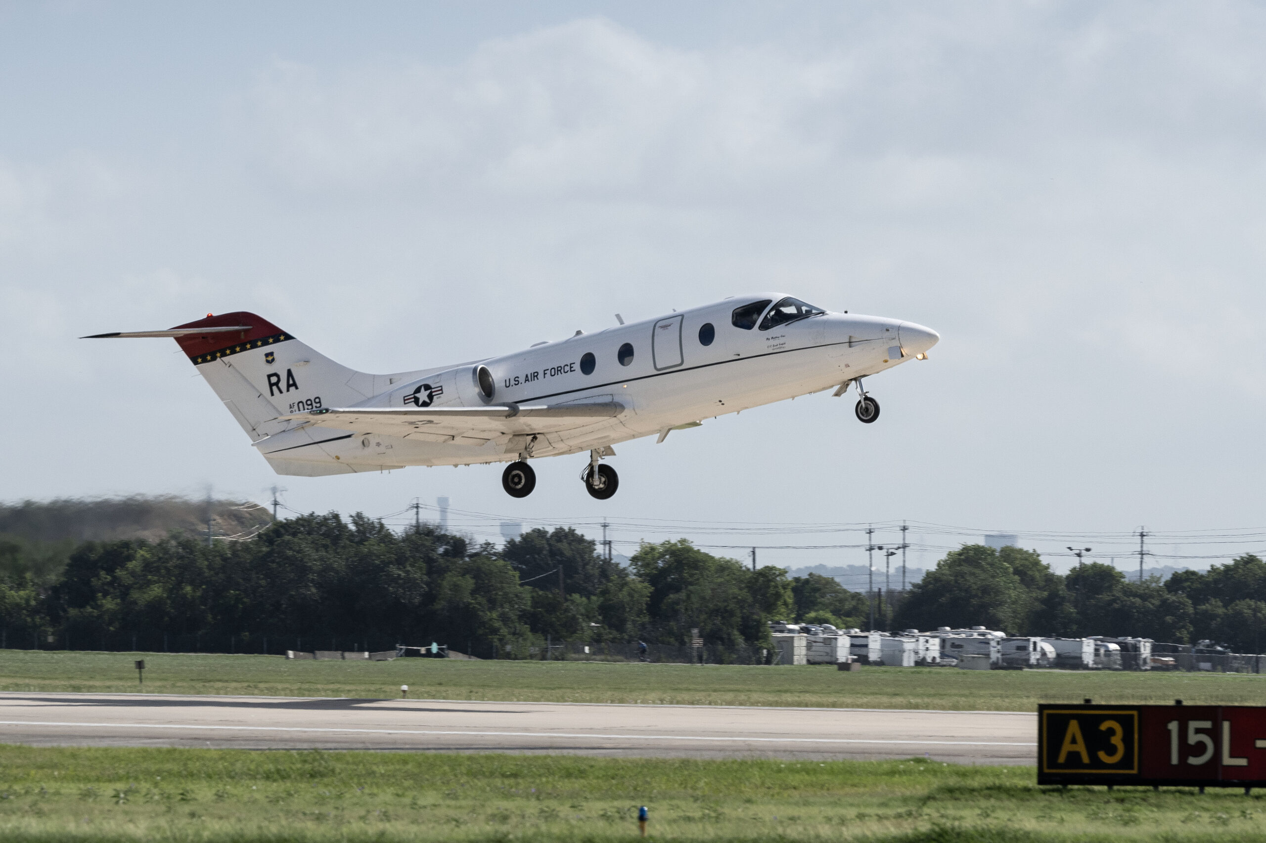 A T-1A Jayhawk flown by Lt. Col. Dominique Haig, 99th Flying Training Squadron commander, Lt. Col. Megan Pasierb and Lt. Col. Christopher Puccia, 39th Flying Training Squadron, takes off during the 99th FTS’s final T-1A flight from Joint Base San Antonio-Randolph, July 15, 2024, at JBSA-Randolph, Texas. The Air Force is shifting its training program from the T-1A to the advanced sixth generation trainer T-7A Red Hawk. The retirement of the T-1A reflects ongoing efforts to enhance training efficiency and effectiveness. (U.S. Air Force photo by Sean Worrell)