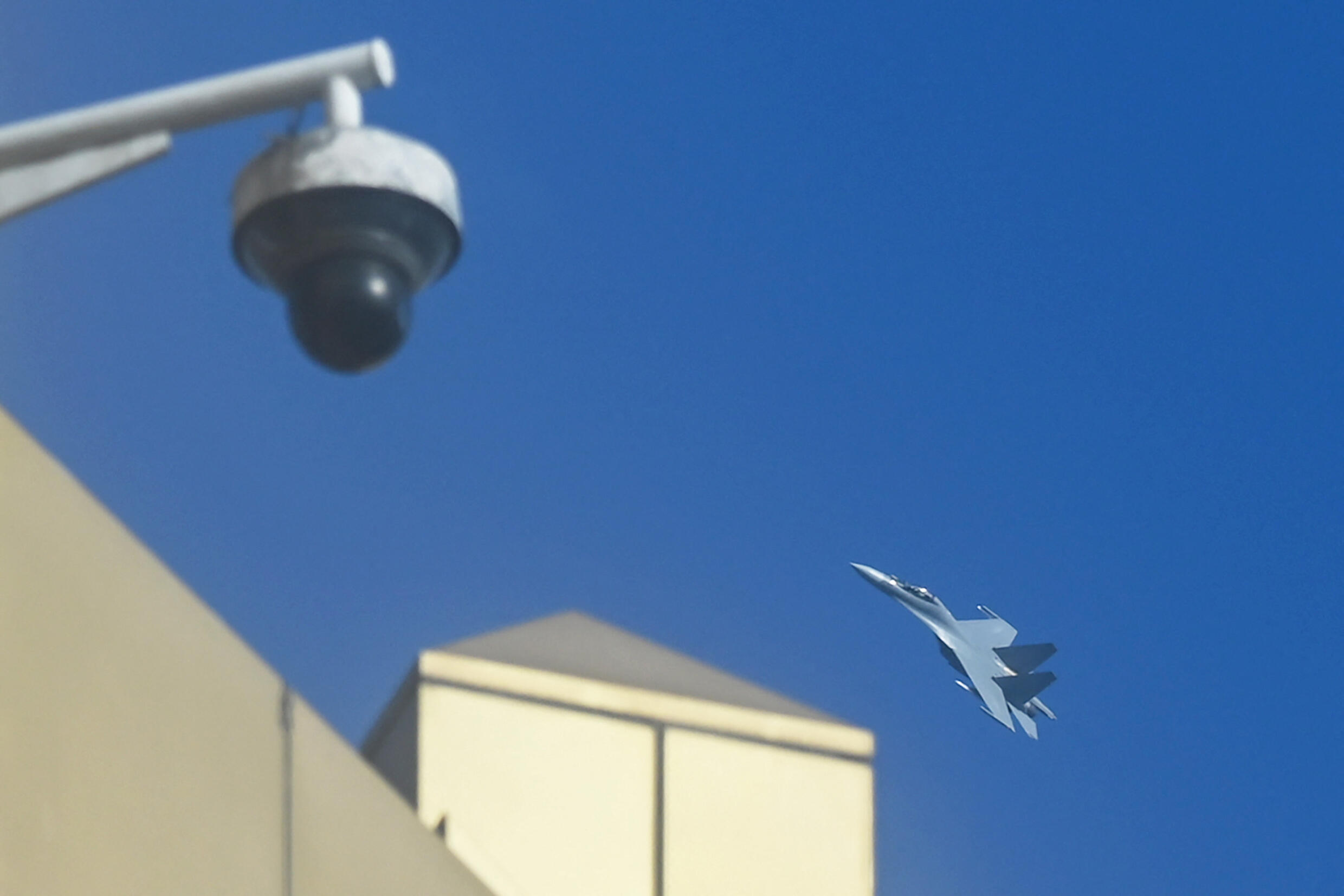A Chinese jet fighter flies above a CCTV camera on Pingtan Island, the closest point in China to the main island of Taiwan, in this photo taken on January 13, 2024