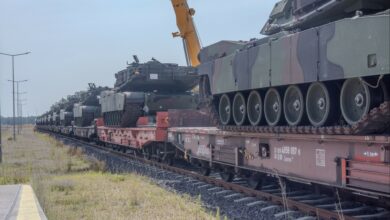 Multiple M1 Abrams tanks wait to be moved from a rail car to the staging area at the Powidz APS-2 Worksite, Powidz, Poland on June 27, 2024. The newly arrived vehicles and equipment will serve as a prepositioned stock for armored brigades deploying or training in the European region, specifically in Poland. (U.S. Army photo by Capt. Michael Mastrangelo)