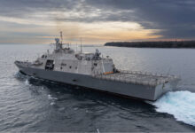 The future USS Nantucket transits the Menominee River in northern Wisconsin, departing for at-sea demonstrations during Acceptance Trials, December 6, 2023. The USS Nantucket is a testament to the enduring partnership between Nantucket, Massachusetts, and the Navy honoring the rich heritage of the people of Nantucket and the maritime legacy that the island represents.