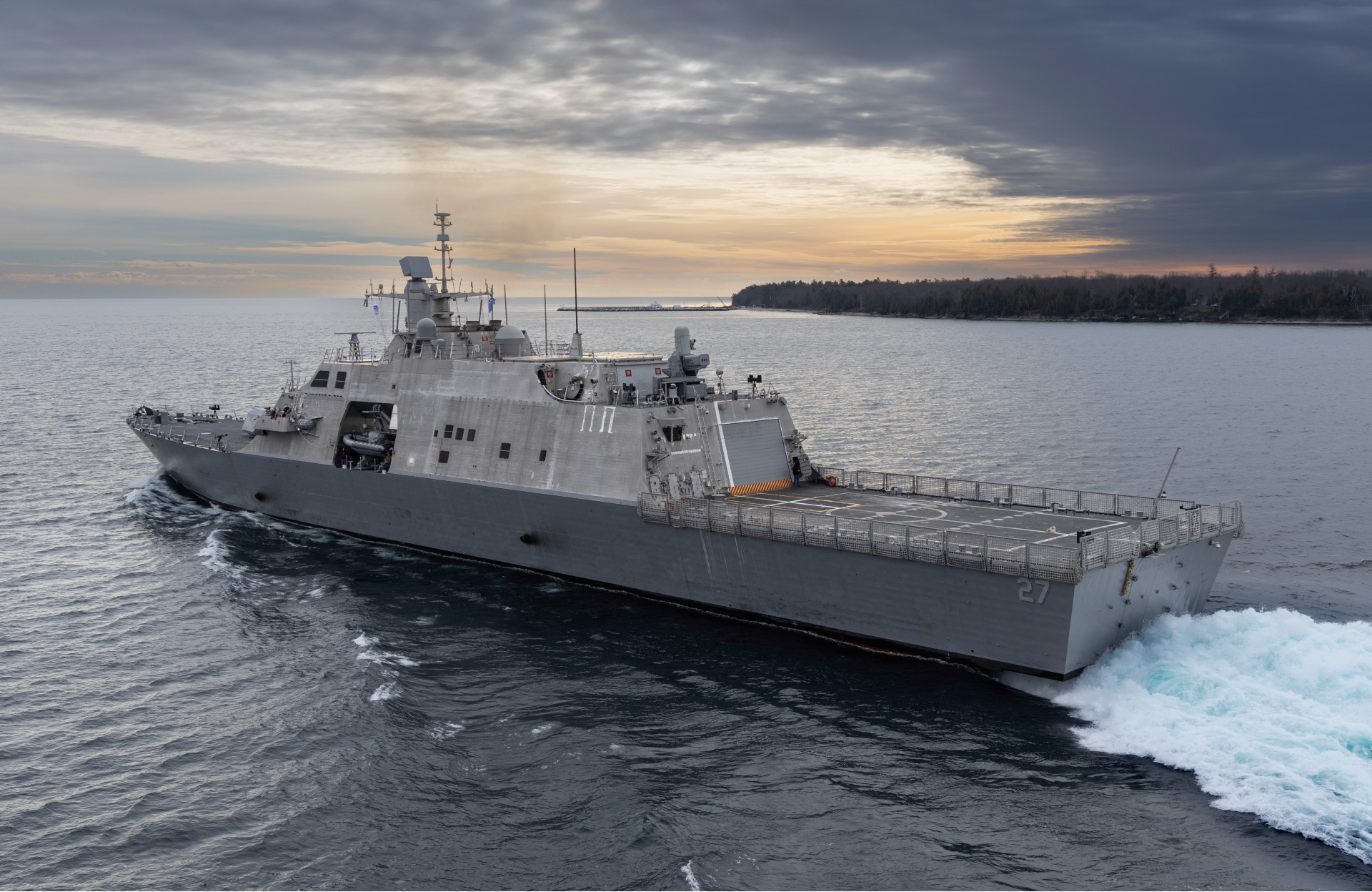 The future USS Nantucket transits the Menominee River in northern Wisconsin, departing for at-sea demonstrations during Acceptance Trials, December 6, 2023. The USS Nantucket is a testament to the enduring partnership between Nantucket, Massachusetts, and the Navy honoring the rich heritage of the people of Nantucket and the maritime legacy that the island represents.