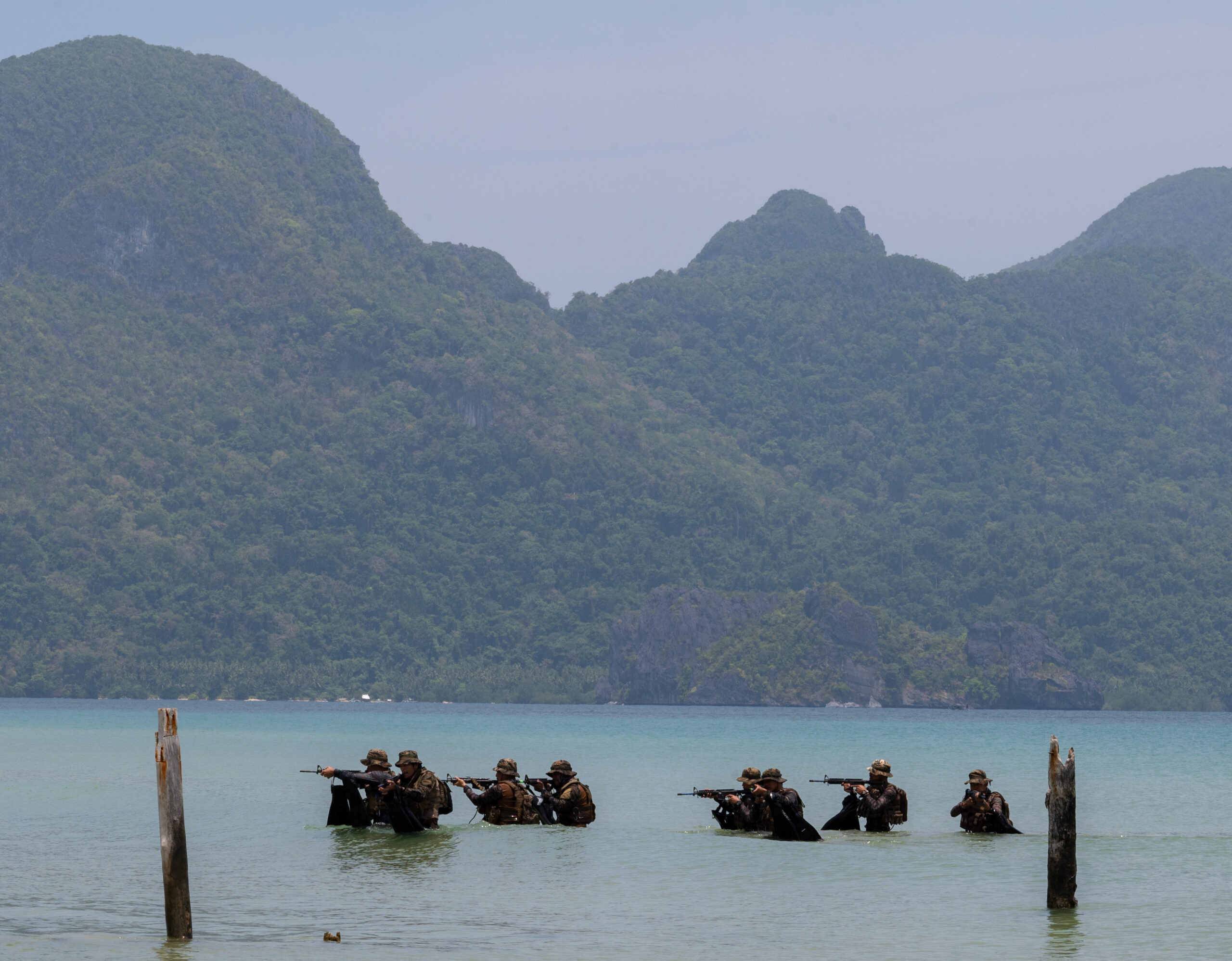 230425-N-OX430-1292 Philippine Sailors assigned to Naval Special Operations Units and U.S. Naval Special Warfare operators conduct over the beach approach drill in preparation for an upcoming bilateral training scenario at Joint Task Force Malampaya in El Nido, Palawan, Philippines during Balikatan 23, April 25, 2023. Balikatan is an annual exercise between the Armed Forces of the Philippines and U.S. military designed to strengthen bilateral interoperability, capabilities, trust, and cooperation built over decades of shared experiences. Naval Special Warfare is the nation’s elite maritime special operations force, uniquely positioned to extend the Fleet’s reach and gain and maintain access for the Joint Force in competition and conflict. (U.S. Navy Photo by Mass Communication Specialist 1st Class Daniel Gaither)