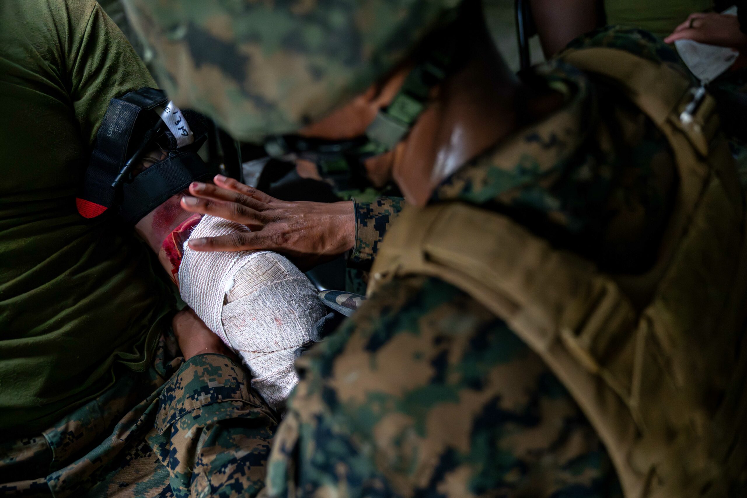 U.S. Navy Hospital Corpsman 3rd Class Matthew Watts with Naval Family Branch Clinic Iwakuni, and a native of California, wraps gauze on a simulated casualty during a mass casualty exercise at Marine Corps Air Station Iwakuni, Japan, June 11, 2024. The exercise was performed to rehearse emergency response procedures and enhance both readiness and efficiency when responding to mass casualty incidents. (U.S. Marine Corps photo by Sgt. Raymond Tong)