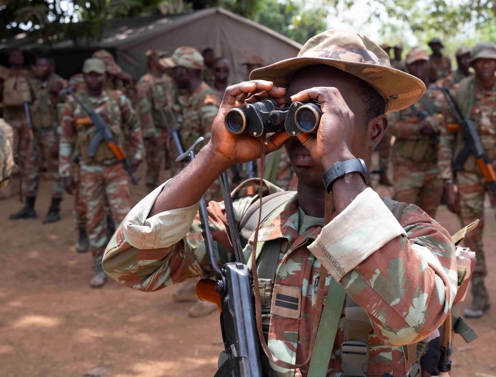 A 1st lieutenant from the Benin 1st Commando Parachute Battalion calibrates his binoculars