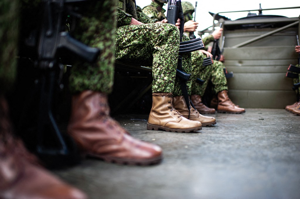 Colombian navy military soldiers sit on a transport truck