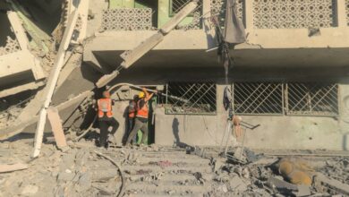 Palestinian rescue team members extinguish a fire in a destroyed building following Israeli bombardment, which hit a school complex in the north of Gaza City on August 3, 2024