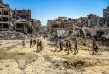 Palestinians walk among the rubble after returning to their neighborhood destroyed during the Israeli military operations lasting for 3 weeks in Jabalia, Gaza