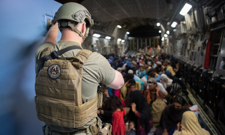 A US Air Force security forces raven maintains security aboard a US Air Force C-17 Globemaster III aircraft in support of the Afghanistan evacuation at Hamid Karzai International Airport