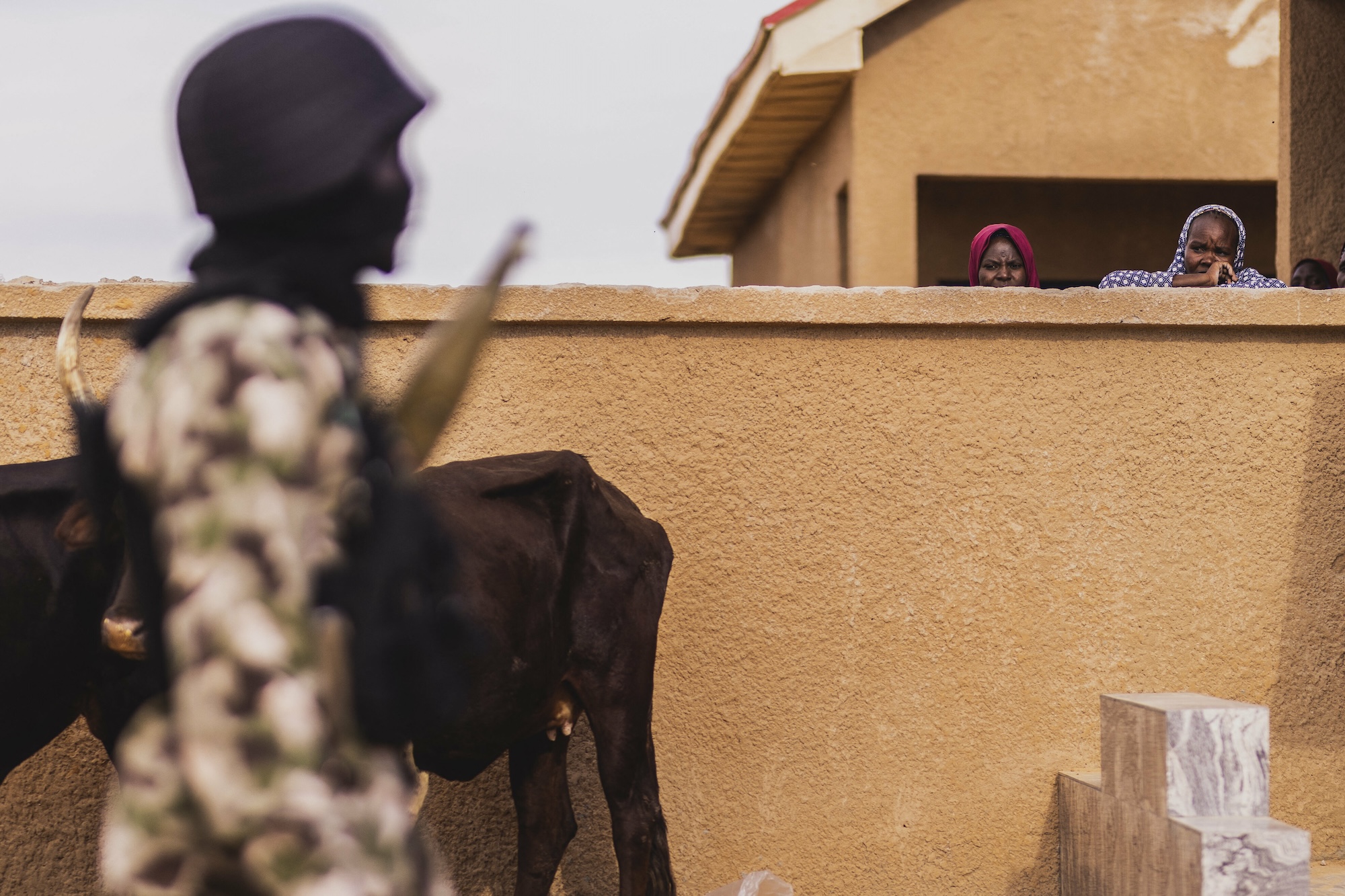 Two women stand out behind a wall in Ngarannam village, located in Borno in north-eastern Nigeria, which was the stronghold of the terrorist organization Boko Haram