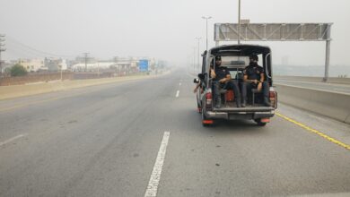 Pakistani police officers in a car on a highway in Lahore