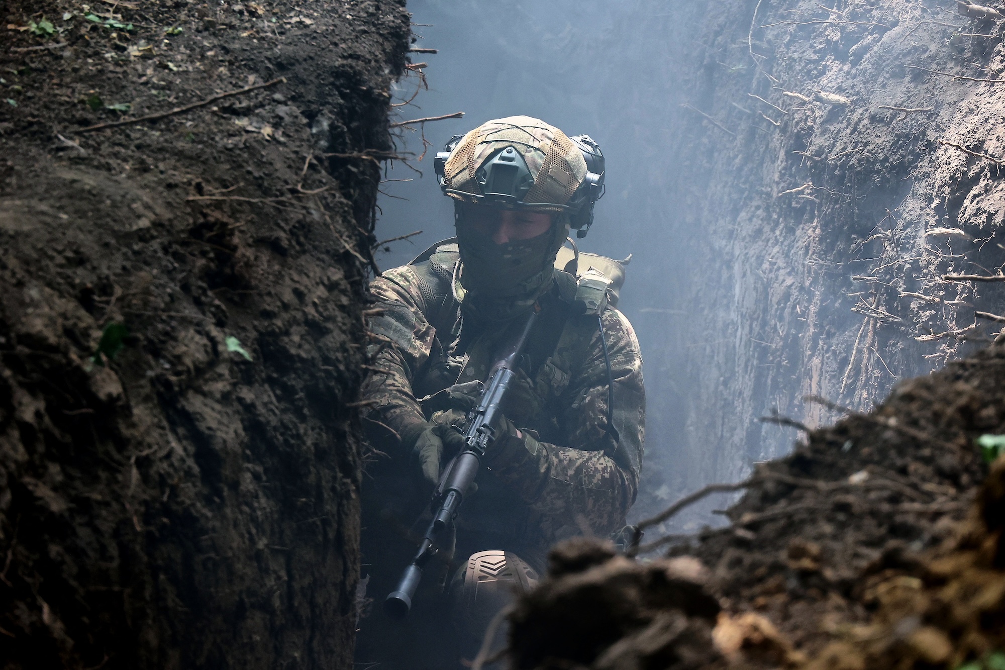 A serviceman of the 3rd Colonel Petro Bolbochan Brigade of Operational Assignment of Ukraine's National Guard is staying in the trench during a tactical exercise in Ukraine