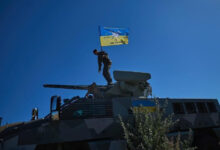 Ukrainian soldier on top of a South African Mbombe 6 armored fighting vehicle. Photo: NMFTE via Telegram