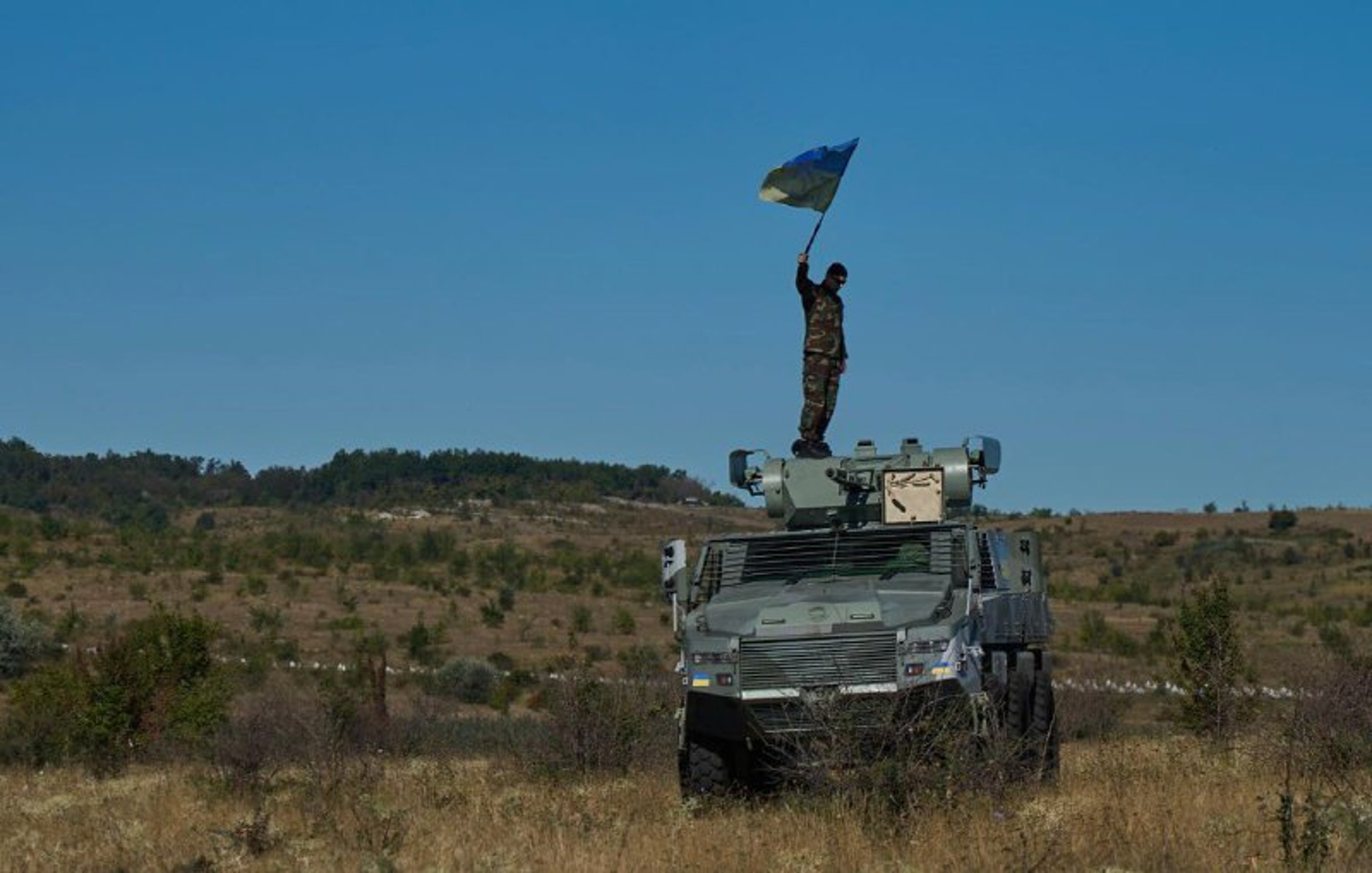 Ukrainian soldier on top of a South African Mbombe 6 armored fighting vehicle. Photo: NMFTE via Telegram