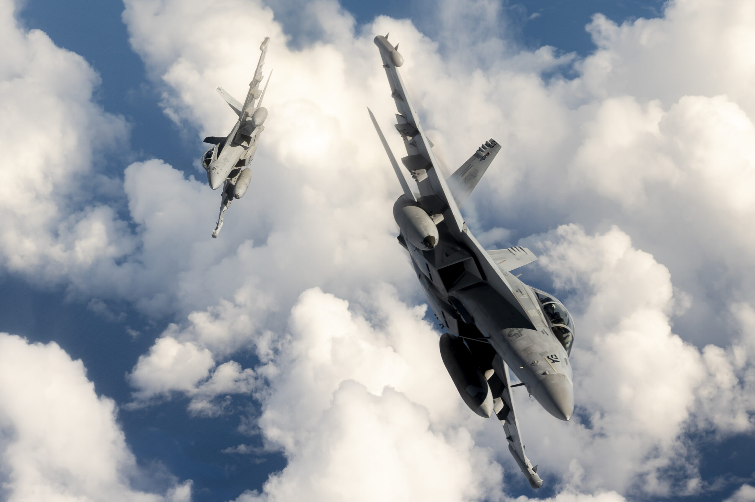 Two U.S. Navy EA-18G Growler aircraft attached to the Electronic Attack Squadron (VAQ) 138 "Yellowjackets", assigned to Carrier Task Force 70, break away from a KC-135 Stratotanker assigned to the 506th Expeditionary Air Refueling Squadron over the Pacific Ocean while flying in support of Exercise Valiant Shield 22 (VS22), June 13 2022. Exercises like VS22 allow forces across the Indo-Pacific the opportunity to integrate Navy, Marine Corps, Army, Air Force, and Space Force to train in precise, lethal, and overwhelming multi-axis, multi-domain effects that demonstrate the strength and versatility of the Joint Force. (U.S. Air Force photo by Master Sgt. Nicholas Priest)