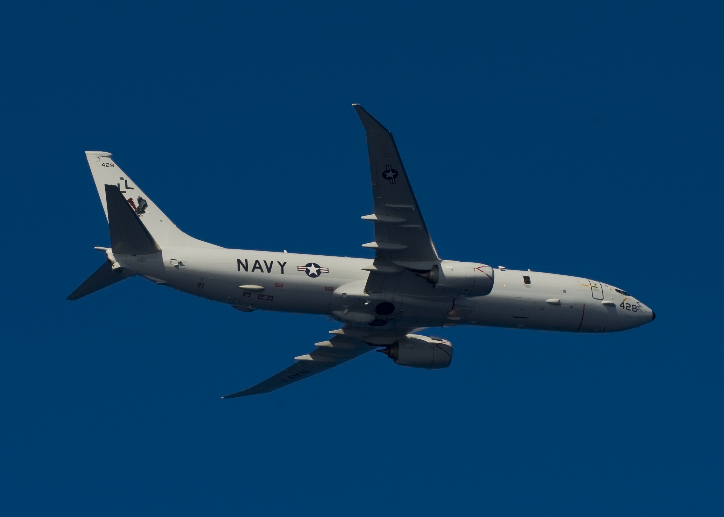 A P-8A Poseidon, assigned to Patrol Squadron (VP) 30, flies over the aircraft carrier USS Harry S. Truman (CVN 75). The P-8A's primary function is anti-submarine and anti-surface warfare and will be the replacement for the P-3C Orion. The U.S. Navy is constantly deployed to preserve peace, protect commerce, and deter aggression through forward presence. (U.S. Navy photo by Mass Communication Specialist 2nd Class Mike DiMestico/Released)