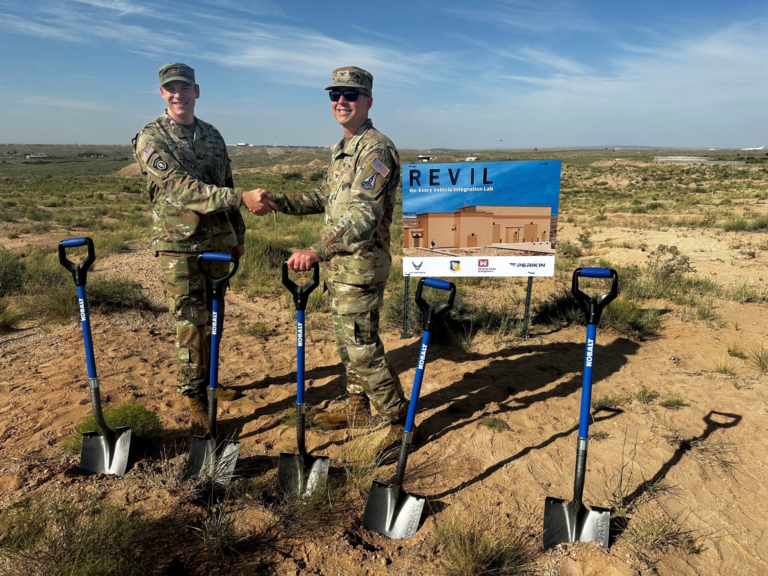 U.S. Army Maj. Jerard Paden, left, deputy district commander, U.S. Army Corps of Engineers, South Pacific Division, Albuquerque District, shakes hands with U.S. Space Force Col. Jeremy Raley, director of the Space Vehicles Directorate, Air Force Research Laboratory, or AFRL, during a groundbreaking ceremony July 29, 2024, at Kirtland Air Force Base, N.M. The ceremony commenced construction for a Re-Entry Vehicle Integration Laboratory, or REVIL, that will serve AFRL’s Nuclear Mission branch and provide lab space for integrating test units for next-generation nuclear research and technology. (U.S. Air Force photo / Jessie Perkins)