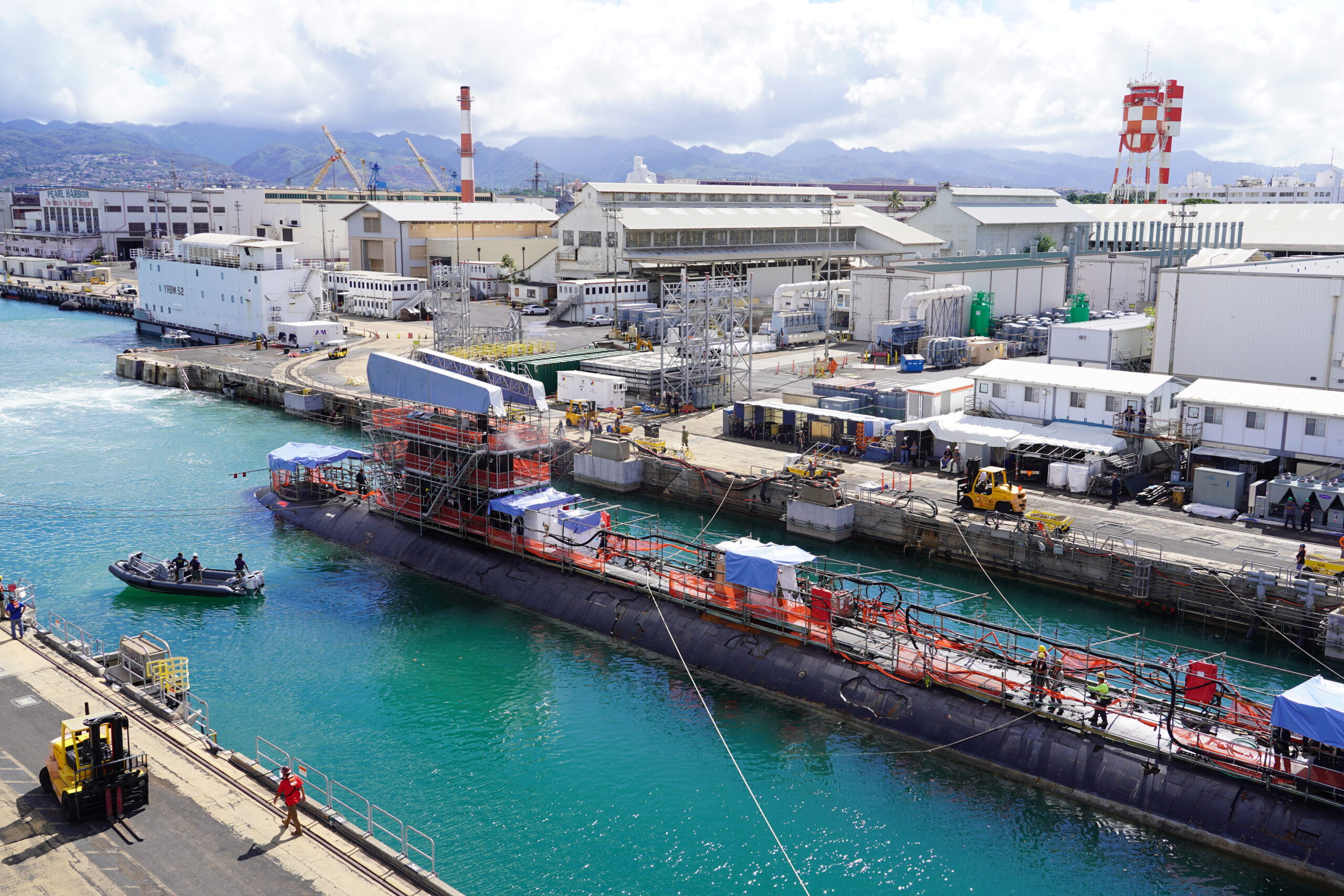 PEARL HARBOR, Hawaii (Sept. 4, 2024) Virginia-class fast-attack submarine USS North Carolina (SSN 777) enters Dry Dock 1 at Pearl Harbor Naval Shipyard and Intermediate Maintenance Facility (PHNSY & IMF) Sept. 4, 2024. North Carolina is at the shipyard for its Depot Modernization Period, where the shipyard project team and ship’s crew will give the vessel its scheduled maintenance upgrades and makeover. PHNSY & IMF’s mission is to repair, maintain, and modernize Navy fast-attack submarines and surface ships, in order to keep the Navy’s fleet “Fit to Fight.” (U.S. Navy photo by Justice Vannatta)