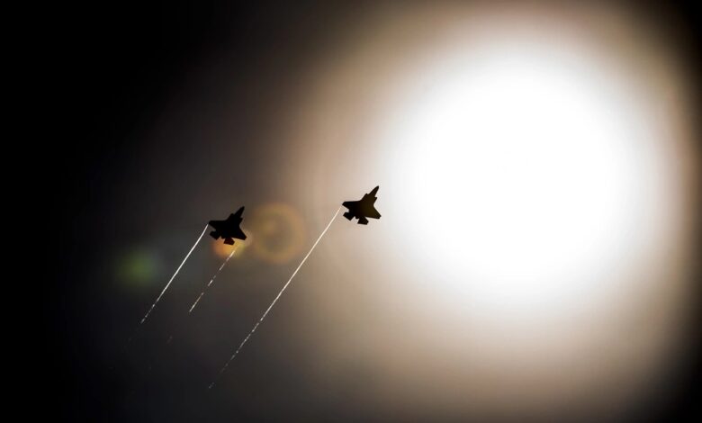 A pair of F-35 Lightning IIs pass under the sun while doing maneuvers to the Eglin Air Force Base runway