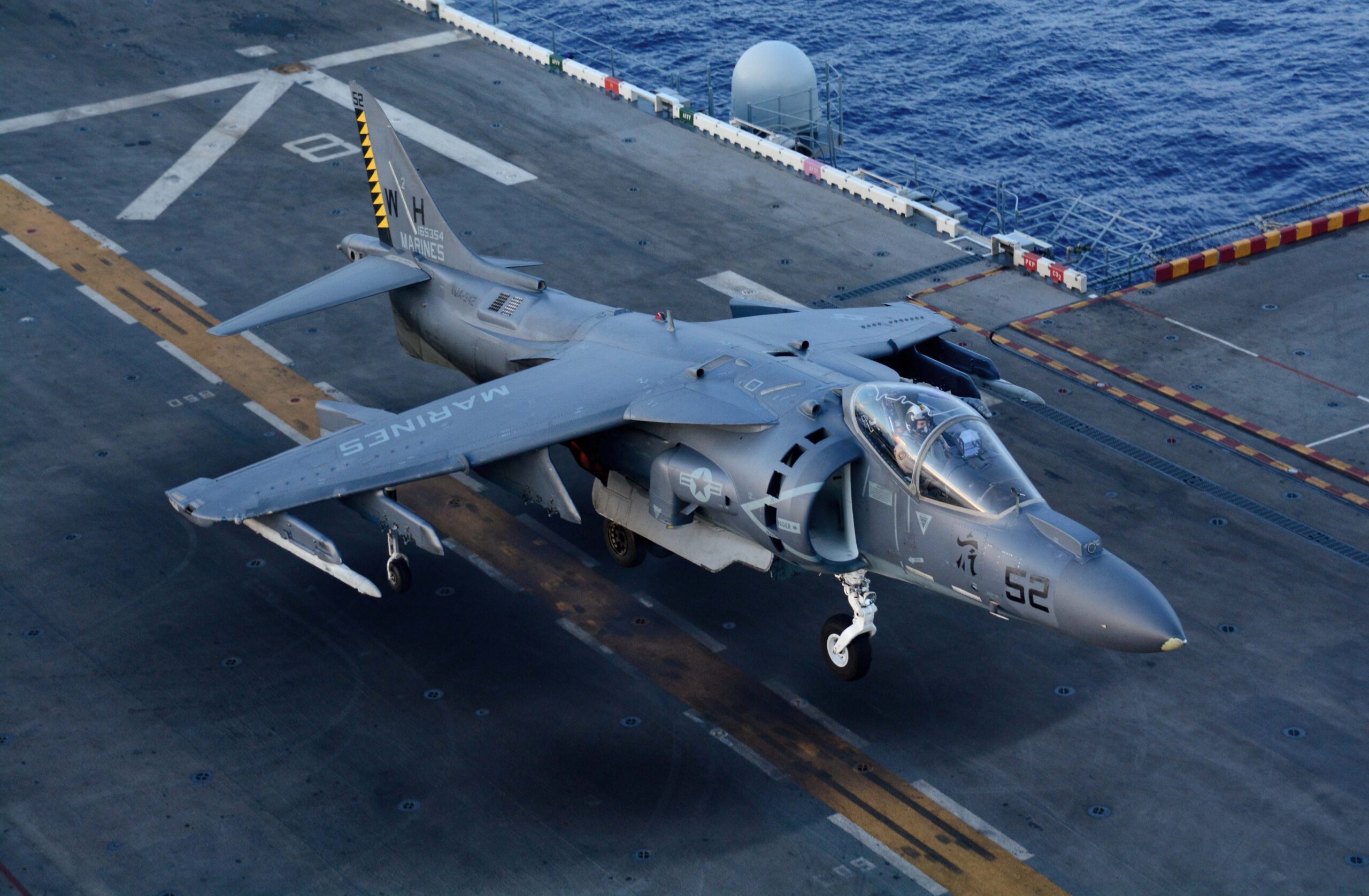 A U.S. Marine Corps AV-8B Harrier II aircraft assigned to Marine Attack Squadron (VMA) 542 lands aboard the amphibious assault ship USS Peleliu (LHA 5) in the East China Sea Sept. 3, 2014. Peleliu was underway in the U.S. 7th Fleet area of responsibility supporting maritime security operations and theater security cooperation efforts. (U.S. Navy photo by Mass Communication Specialist 3rd Class Dustin Knight/Released)