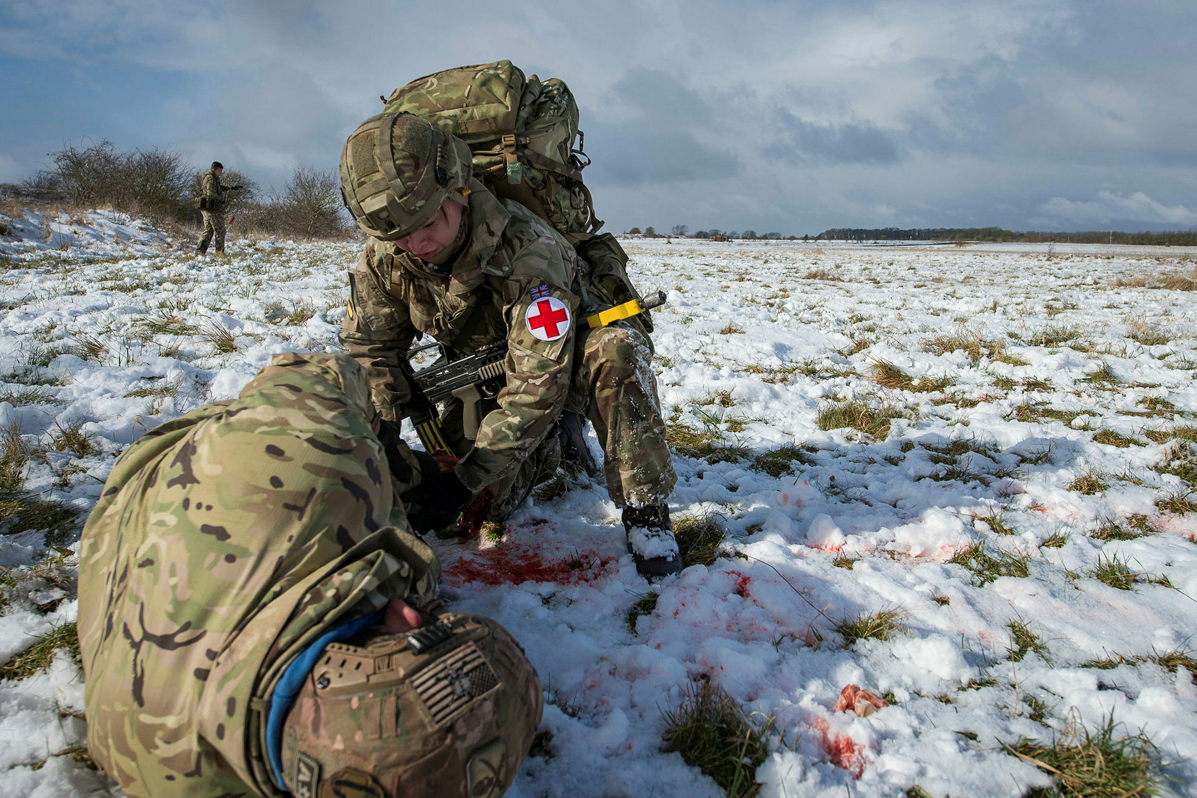 3 Medical Regiment Role 1 validation training Army medics have been training to give life-saving care – even under fire. Full-time Regulars and spare-time Reservists, including those of Preston-based 3 Medical Regiment, have this week been tested on the frozen North Luffenham training area in the Midlands. A battlefield environment was simulated using blank ammunition and actors, but Combat Medical Technicians know that one day they might be asked to do it for real. The ‘care under fire’ scenario is designed to see how medics will react while attending to a casualty under a hail of bullets. Soldiers must apply immediate first aid and carry the wounded, including the casualty’s 40kg of kit, whilst others provide covering fire. Extra tests staged during the training examined their ability to treat conditions as varied as chest infections and gunshot wounds, all from nothing more than a tent. Once completed, the exercise qualifies the Army Medical Services’ first responders to fulfil their role anywhere in the world. Photographer: Sergeant Donald Todd (RLC) / MoD Crown Copyright read less