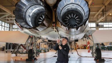 Technical support personnel conducting a maintenance on aircraft engine