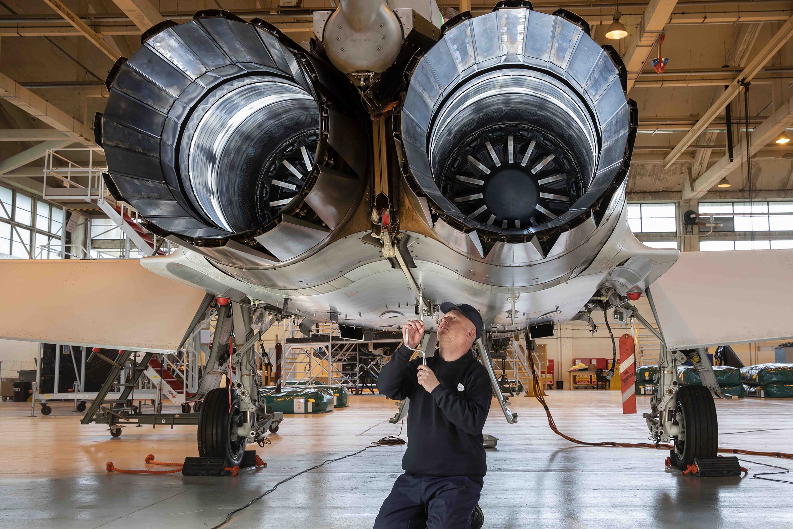 Technical support personnel conducting a maintenance on aircraft engine