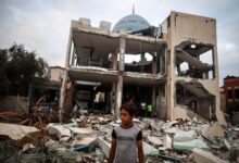 A Palestinian inspects the damage to a mosque after it is hit in an Israeli strike in Deir al-Balah, central Gaza Strip, on October 6, 2024