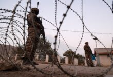 Indian soldiers stand alert while frisking vehicles and suspected persons in Baramulla, Jammu and Kashmir, India