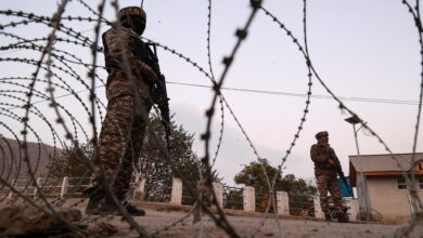 Indian soldiers stand alert while frisking vehicles and suspected persons in Baramulla, Jammu and Kashmir, India