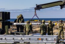 Soldiers from the Air Defense Battalion at Evenes load a NASAMS launcher with an AIM-120C-7 AMRAAM missile during Exercise Silver Arrow at Nordmela