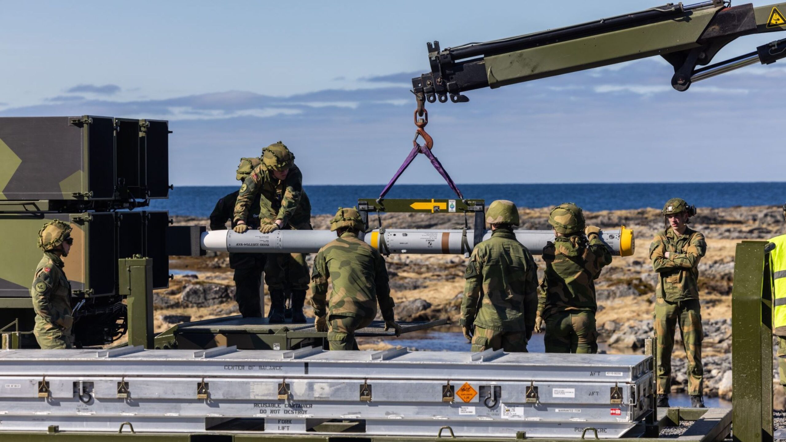 Soldiers from the Air Defense Battalion at Evenes load a NASAMS launcher with an AIM-120C-7 AMRAAM missile during Exercise Silver Arrow at Nordmela