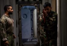 A US Coast Guard Maritime Law Enforcement Specialist oversees Pakistan Navy members during a visit, board, search and seizure training