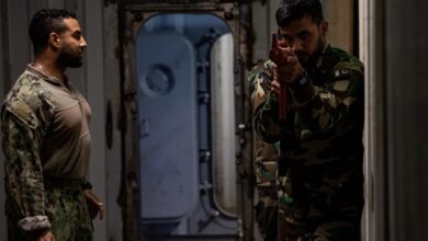 A US Coast Guard Maritime Law Enforcement Specialist oversees Pakistan Navy members during a visit, board, search and seizure training